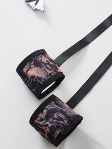 Détail de manches à imprimé crâne gothique avec rubans noirs pour lingerie Halloween