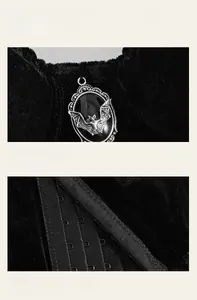 Detail of velvet corset top with silver bat pendant and multi-row hook-and-eye closure