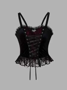 Detailed view of the velvet corset top with red lace, lacing, and bat pendant
