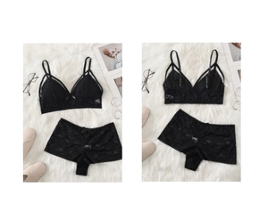 Flat lay of black lace lingerie set with bralette and shorts on white fur background