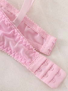 Detail of pink floral lace bra back closure with three-row hooks and adjustable straps