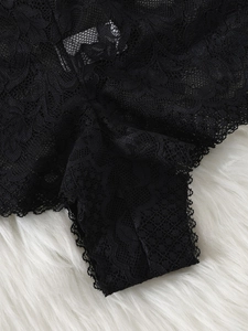 Close-up detail of fine black floral lace fabric on women lingerie boyshorts