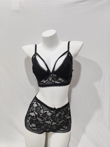 Detail view of black floral lace lingerie set featuring a bow bra and matching boy shorts