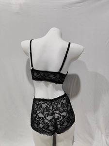 Back view of black floral lace lingerie set with adjustable straps on white mannequin
