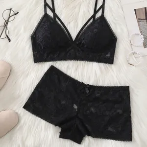 Sexy black lace lingerie set with wireless triangle bra and boyshort panties on white rug