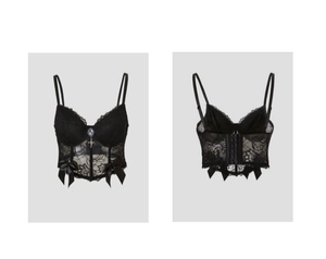 Detail of black lace corset top with blue gemstone pendant and satin bows on the hem