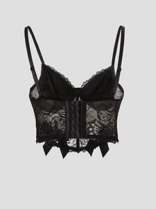 Detail of black lace corset top featuring back hook-and-eye closure and adjustable straps