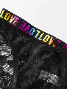 Detail of black lace panties featuring a rainbow LOVE waistband and a small bow detail