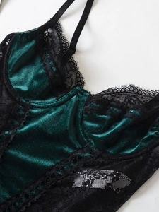 Detail of dark green velvet camisole with black floral lace stitching and slim straps