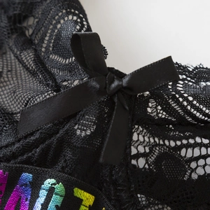 Black lace lingerie set with rainbow letter charms and a soft satin bow detail