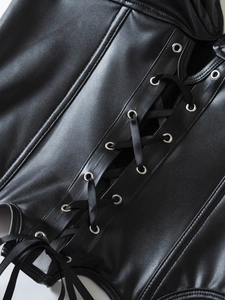Detailed macro of black PU corset featuring silver metal eyelets and satin lace-up ties