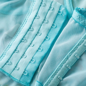 Vista posteriore del corsetto in mesh blu menta con chiusura a gancetti su quattro file
