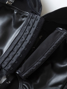 Detail of three-row metal hook-and-eye closure on a black PU leather gothic corset top