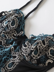 Detail of floral lace embroidery and paisley patterns on black mesh bodysuit for women