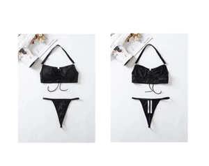 Detail view of a black two-piece bikini set with halter neck and cross-tie details