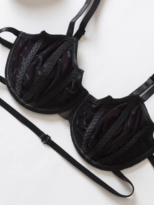 Close-up of black velvet Gothic lace bra featuring dark red mesh lining and underwire support