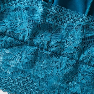 Lace camisole top in dark peacock blue featuring intricate floral embroidery and textures