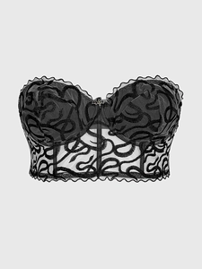 Detail of gothic mesh corset with snake embroidery and a metal bat pendant on the neckline