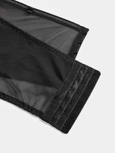 Macro view of adjustable hook-and-eye back closure on black gothic mesh corset