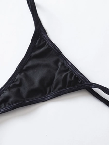 Detail of black satin bikini top featuring silky fabric and premium stitching craft