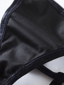 Macro shot of breathable black fabric with fine mesh texture and reinforced stitching edge