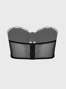 Detail of gothic black mesh corset featuring back hook-and-eye closure and lace trim