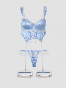 Detailed view of light blue satin lingerie set with white lace trim and corset ribbons