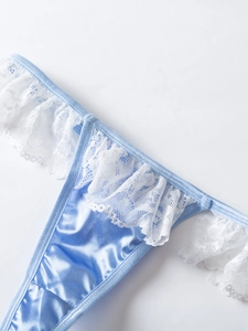 Detail of light blue satin lingerie with intricate white lace trim and fine stitching