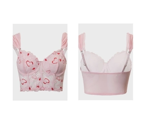 Detail showing pink lace bustier top with red heart prints and adjustable straps
