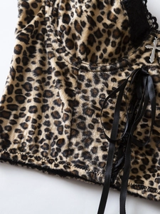 Close-up of leopard print velvet camisole with black lace trim and silver cross pendant
