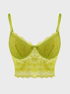 Detailed close-up of lime green lace bustier top with floral patterns and underwire cups
