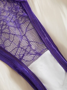 Detail of purple floral lace lingerie with satin trim and soft white inner lining