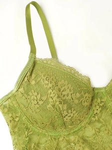 Close-up of grass green lace camisole with floral patterns and eyelash lace trimming