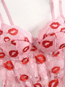 Detailed pink lace bustier with red lip prints and heart embroidery detailing