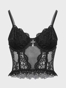 Close-up of black lace bustier top with mesh panels and silver cross pendant detail
