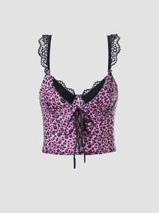 Detail of Y2K pink leopard crop top with black lace trim and metal cross pendant