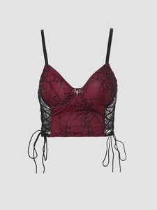 Detail of gothic spiderweb lace camisole with bat metal pendant and side lacing