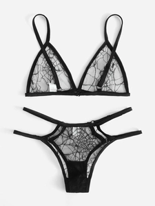 Close-up of semi-transparent black lace lingerie set with mesh patterns and washing label