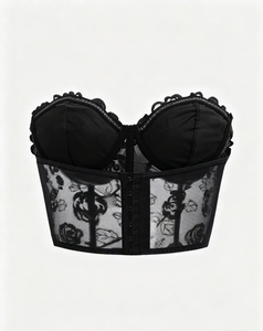 Detailed close-up of black floral lace embroidery and satin finish on the corset top
