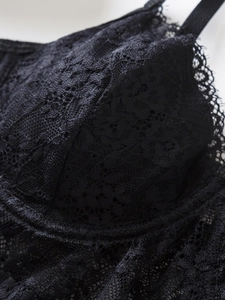 Close-up of black lace camisole showing delicate floral patterns and wire support details