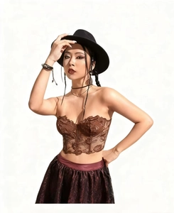 Detailed view of vintage brown lace corset with intricate rose embroidery and boning