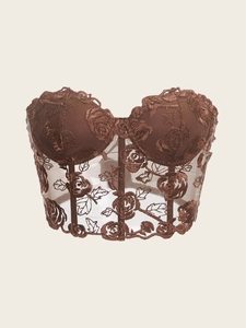 Detailed macro view of the brown rose embroidery and mesh boning on the corset top