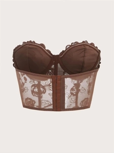 Detailed view of the back hook-and-eye closure on this brown lace floral corset top