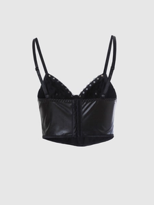 Close-up of black leather corset with silver metal rivets and adjustable straps