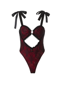 Detail of red gothic bodysuit featuring black spider web lace and skull pendant