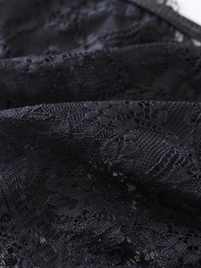 Macro detail of high-quality black floral lace fabric with intricate mesh texture
