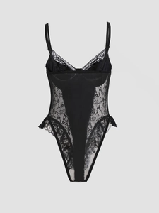 Detail of floral lace stitching and semi-transparent mesh on a black bodysuit