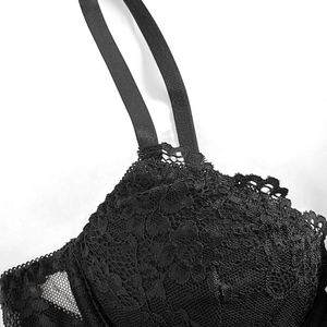 Black lace bustier corset top with floral embroidery and mesh paneling on white background