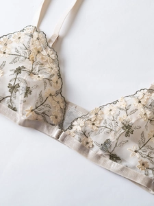 Detail of French floral embroidery on sheer mesh bra with front buckle closure