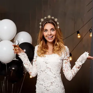 Golden celestial halo headband with star elements worn by a model in a party setting
